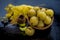 Close up of green colored herbal and organic oil of amla or Indian gooseberry in a transparent bottle with raw amla in a basket