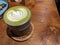 Close up green matcha latte over the wooden table on the cafÃ© and resto