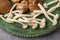 Close-up of a green metal plate with white shiitake and shimeji mushrooms, with selective focus