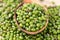 close up green mung beans in wooden spoon on wood plate