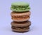 The close up of green, orange and brown macaron.