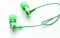 Close-up of green portable headphones for smart work online meetings and conference calls, devices for the phone