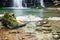 Close up on green turquoise creek lake by beautiful Waterfall Virje in long exposure, Slovenia