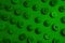 A close up of a green wall with many buttons. AI generative image