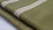 a close up of a green and white fabric with a white stripe on it and a white stripe on the side of the fabric and a white stripe