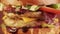 Close-up of a grilled chicken burger rotation on a brown background.