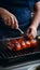 Close up of grilled red pork with chef cooking in kitchen