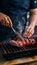 Close up of grilled red pork with chef cooking in kitchen