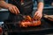 Close up of grilled red pork with chef cooking in kitchen