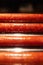 Close-up of grilled sausages in a cafe, which are fried to a brown crust. Cooking ingredients for a hot dog. Vertical photo