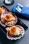 Close up Grilled scallop in shell with spicy pomelo salad served in black plate