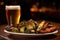 close-up of grilled vegetables and a pint of amber craft beer