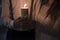 Close up of groom and bride holding one burning candle