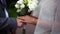 Close up. The groom gives the bouquet to the bide. Bridal bouquet. A man gives flowers to a woman. Wedding flowers.