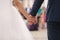 Close up of groom hold bride`s hand in front of guests. Wedding ceremony. Back view