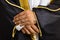 Close-up of groom\'s hands with engagement ring.