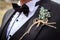 Close-up groom in tuxedo with boutonniere