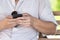 Close up a groom is typing message in the moblie phone