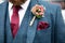 Close up of groom wearing tweed suit and boutonniere