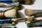 Close up of group of artist`s paintbrushes showing their stained bristles