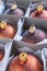 Close-up of a group of bronze colored christmas balls in a cardboard box