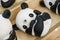 Close-up of a group of ceramic graffiti panda dolls