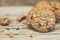 Close up of a group Chocolate chip cookies many stacked on dark old rustic wooden plank table