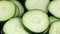 Close-up of group of fresh cucumber slices floating in liquid