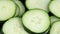 Close-up of group of fresh cucumber slices floating in liquid