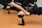 Close-up group of girls hanging on bungee rubber bands in the gym. Girls perform a difficult exercise with bungee gum.