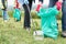 Close Up Of Group Of Helpful Seniors Collecting Litter In Countryside