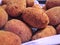 Close up of a group of Italian supplÃ¬, traditional fried rice balls