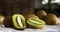 Close-up of a group of kiwis, one of them cut in half. Dark background