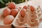 Close up group of organic eggs in brown carton box on wooden background