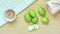 Close-up group of raw green mango and slices mango on wooden table background. With a wooden bucket and clean green and white chec