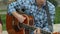 Close-up of of a guitar playing on the street