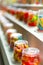 Close-up of gummy worms in cups on a carnival stand