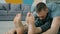 Close-up of guy practising forward bends doing yoga at home in apartment