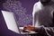 Close up of hacker hand using laptop with creative drawn email icons on purple background. Business, technology, communication and