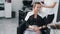 Close up of hairdresser hands applying hair mask on hair of young woman