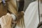 Close up of hairdresser hands drying human hair with equipment. Woman holding a comb. close-up. Macro photo