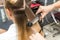 Close-up of a hairdresser straightening