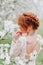 Close-up hairstyle of a red-haired bride, rear view.