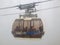 Close up of Hakone Ropeway cable car with passengers inside.