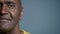 Close-up half male face mature african american man looking camera middle-aged client patient posing in studio gray