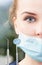 Close-up of half woman dentist face wearing mask
