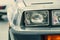 Close-up halogen headlight of white retro car