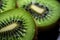 Close up of halved kiwi fruit with water drops