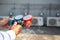 Close up hand of air repairman using manifold gauge is measuring equipment for filling industrial factory air conditioners after c