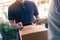 Close up of hand asian man using smartphone pressing screen to sign for delivery from the courier at home